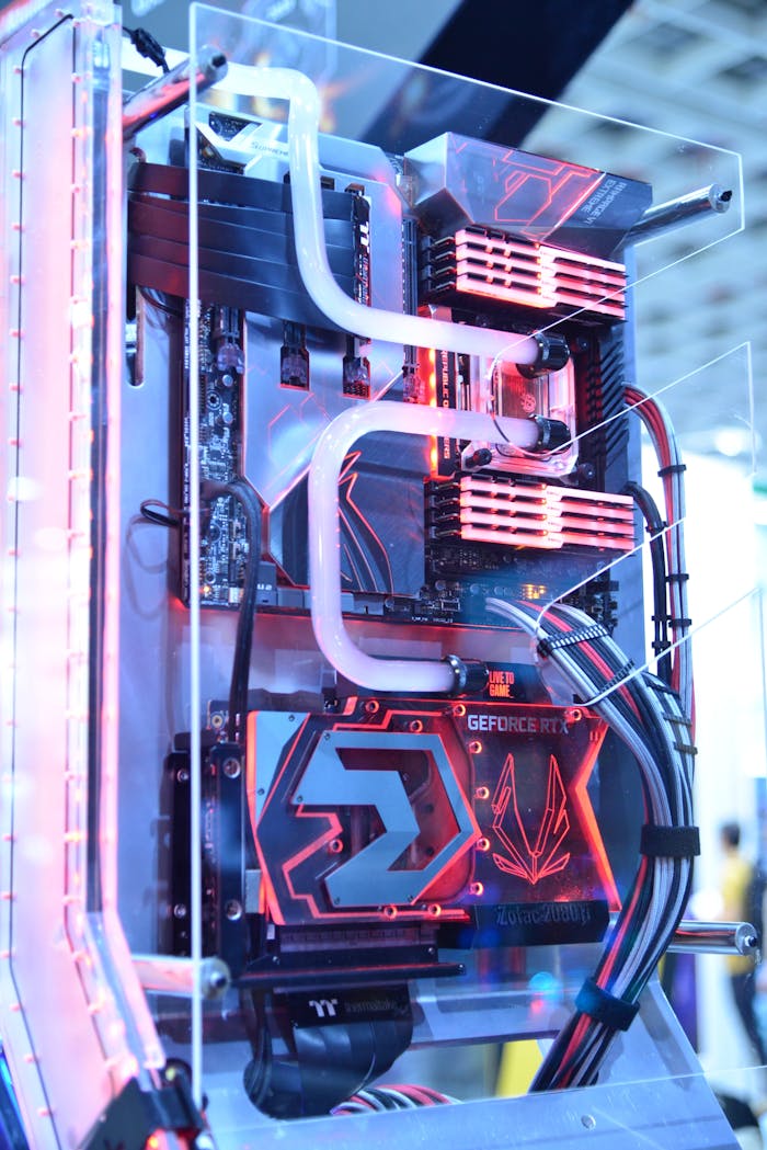 our-services-1 Close-up view of a custom gaming PC with water cooling and LED lights, highlighting advanced technology.